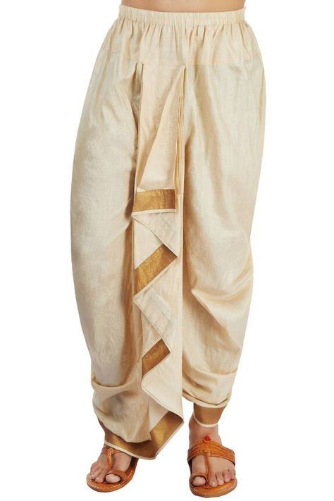 Beige draped dhoti with an elastic waistband, a centre front patli that is continued to the back and a gold border at the hem. Components: 1 Fabric: Monga silk Color: Gold Other details: Centre front patli Gold border Elastic waistband Note: The kurta worn by the model is not for sale. - Aza Fashions Kurta Ideas, Dhoti Pants For Men, Wedding Dresses Men, Tassels Designs, Saree Tassels Designs, Wedding Dresses Men Indian, Eyes Aesthetic, Saree Tassels, Fall Fashion Coats