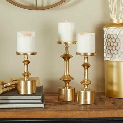 CosmoLiving by Cosmopolitan Gold Aluminum Pillar Candle Holder (Set of 3) - Bed Bath & Beyond - 38297198 Global Leadership Summit, Gold Taper Candle Holders, Gold Pillar Candles, Pillar Candle Stand, Pillar Candle Decor, Decorative Pillars, Round Candle Holder, White Candle Holders, Leadership Summit