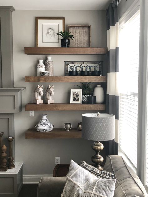 Wood floating shelves next to gray mantle. Joanna Gaines inspired farmhouse decor. Corner Living Room Shelves, Living Room Wood Shelves, Fireplace Wall With Floating Shelves, Floating Shelves With Mirror, Shelf Decor Living Room Wall Shelves, Shelves In Living Room Wall Shelves, Floating Shelves Around Fireplace, Living Room Wall Shelf Ideas, Large Empty Wall Ideas Living Rooms