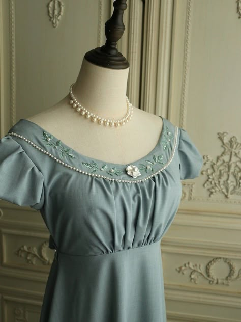 Experience the timeless elegance of the Regency era with this stunning grayish blue Bridgerton-inspired dress. Perfect for brides and special occasions, this dress beautifully blends vintage charm with modern sophistication. Timeless Design: Featuring a classic Regency silhouette, this dress boasts puffed sleeves and a gracefully flowing skirt. The floral appliqués and intricate beaded details along the neckline add a touch of refined elegance. Exquisite Details: The gown is adorned with delicate floral appliqués and beadwork, exuding sophistication and luxury. The back is tied with a ribbon belt, ensuring a flattering fit and adding to the dress's elegant design. Premium Quality: Made from high-quality fabric, this dress offers a soft and luxurious feel. The meticulous craftsmanship is ev Regency Silhouette, Regency Era Dress, Nontraditional Wedding Dress, Wedding Dresses High Low, Floral Applique Dress, Champagne Evening Dress, Bridgerton Inspired, Fairy Wedding Dress, Sequin Evening Gowns