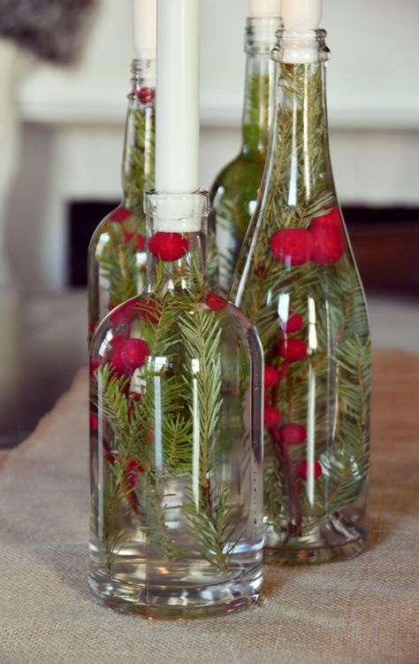 Easily make upcycled Christmas decorations: try this super easy candle centerpiece that uses upcycled bottles and colorful berries. #["Christmas", "Curbly-Original", "How-To", "Creative Reuse", "Recycling & Upcycling", "crafting", "centerpiece", "Holiday", "Candle"] Simple Candle Centerpieces, Glass Bottle Centerpieces, Wine Bottle Candle Holder, Upcycled Bottles, Bottle Candle Holder, Upcycled Christmas, Wine Bottle Centerpieces, Wine Glass Candle, Bottle Centerpieces