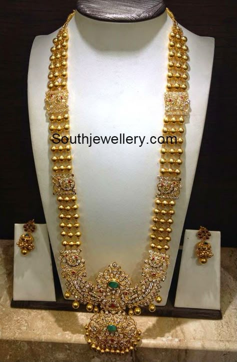 22 carat gold gundla haram with beautiful peacock design stones pendant studded with cz stones, rubies and emeralds. Weight: 110 grams For inquiries contact on Whatsapp: +91 97 00 009000 or Email: dharmesh25@yahoo.com Related Posts72 Grams Gundla Mala with Pachi PendantKundan Long HaramUncut Gold Balls Necklace and Haram Set85 Grams Chandraharam with Side PendantsAntique Gold Saree Inspiration, Gold Long Chain, Unique Saree, Latest Jewellery Designs, Gold Haram, Haram Designs, Indian Jewellery Gold, Long Haram, Outfits Unique