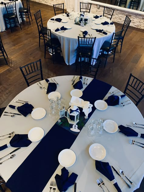 Simple yet elegant wedding reception decor. Navy napkins with rhinestone napkin holder. Centerpieces are white lanterns with navy and silver accents. Central Florida wedding planners. Wedding Decorations Navy Blue, Navy Blue And Silver Wedding, Navy Wedding Decorations, Silver Wedding Reception, Silver Wedding Centerpieces, Blue And Silver Wedding, Silver Wedding Theme, Blue Silver Weddings, Blue Table Settings