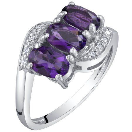 Adorn yourself or a loved one with this 1.25 ct Oval Amethyst and Diamond Three-stone Anniversary Ring in 14K White Gold. This ring features exquisite 1.25 carat total weight natural Amethyst gemstones. Precisely cut and crafted, the oval shape Amethyst gemstone, measuring 6 x 4 mm, radiates a vibrant purple color. This three-stone style ring features a secure prong setting and is accented with dazzling diamond side stones. The diamond accent stones are brimming with beauty with an I1 clarity an Colored Stone Engagement Rings, Gem Engagement Rings, Jewelry Questions, Moonstone Engagement Ring Set, Special Engagement Ring, Gemstone Diamond Ring, Precious Rings, Amethyst And Diamond Ring, Moonstone Engagement Ring