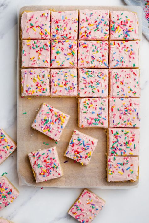 Thick, chewy Sugar Cookie Bars are topped with a sweet frosting and sprinkles! This is such an easy recipe that is perfect for literally any occasion! Get creative and decorate them in bright colours for Easter! #cookie #bars #dessert #sugarcookie Sugar Cookie Bars Southern Living, Southern Living Sugar Cookie Bars, Valentine Sugar Cookie Bars, Summer Dessert Bar Recipes, Sugar Cookie Sheet Bars, Funfetti Sugar Cookie Bars, Cooking With Karli Sugar Cookie Bars, Easy Sugar Cookie Bars Cake Mixes, Sugar Cookies Bars Recipe