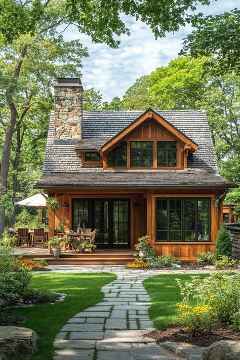 Modern small cottage with wood stain siding slate shingle roof stone chimney deck with plant beds neat lawn paved path. Fall in love with these small but charming and cozy small houses, from cottages to modern cabins. Live tiny at large! Lake Cottage Exterior Ideas, Adirondack Cottage, Small House With Lots Of Windows, Cedar Shake Cottage Exterior, Small Two Story Cottage, Small Craftsman Cottage, Witchy Cottage House Plans, English Stone Cottage House Plans, Cottage In The Woods House Plans