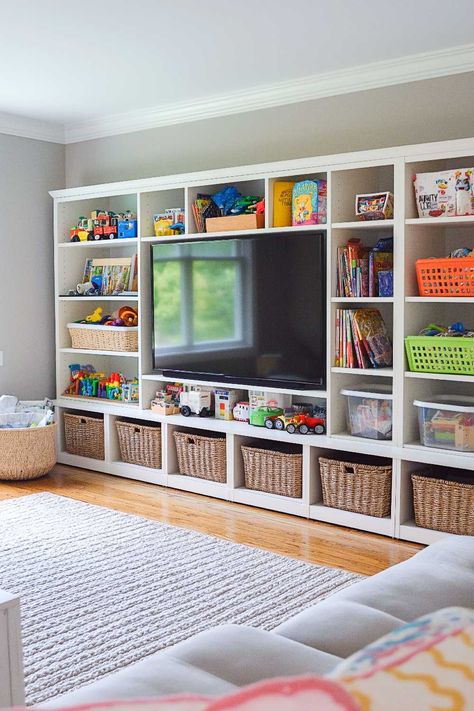 50+ Living Room Toy Storage Ideas That Keep Everyone Happy Playroom Desk And Storage, Bonus Playroom Ideas, Kids Toy Room Storage, Kids Game Storage Ideas, Melissa And Doug Puzzle Storage, Bonus Room Furniture Layout, Megablocks Storage Ideas, Lego Storage And Display, Living Room Inspiration Kid Friendly