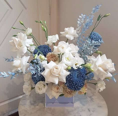 Blue Gold White Floral Arrangements, Powder Blue Centerpieces, Monochromatic Flower Bouquet, Blue And Tan Flower Arrangements, White And Light Blue Flower Arrangements, White Blue Flowers Arrangements, Blue Flowers Table Decoration, Blue And White Flower Centerpieces, Monochromatic Floral Arrangements