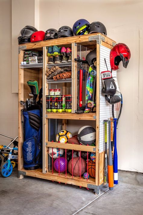 Tired of organizing and taking out sports equipment for weekly practice. Storing sports equipment can feel a bit overwhelming, but luckily we have the perfect solution to keep all your equipment in one place. Our DIY Sports Equipment Organizer provides ample storage with separate compartments and shelves to keep everything neatly organized. Build it today following our guided step-by-step free downloadable plan on our blog Sports Equipment Organization, Connecticut House, Garage Hacks, Sports Equipment Storage, Garage Storage Inspiration, Gear Room, Sports Storage, Garage Organisation, Shed Organization