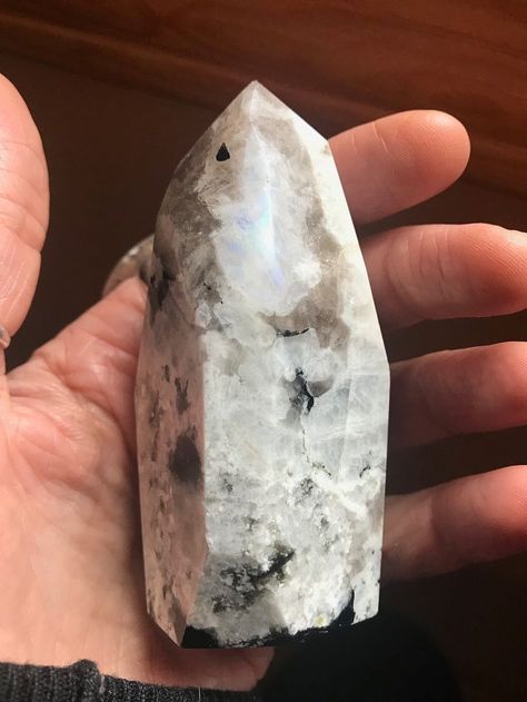 Moonstone is a favorite and very popular crystal. It's one that many of us are attracted to for its trademark blue flash.  Everybody loves that inner sparkle right?  Today, we're going to talk all about moonstone's healing properties, correspondences, and meanings. #moonstone #crystals #crystalmenaings #crystalhealing #crystalcorrespondences #wellness #selfcare #lunarenergy #goddess #divinefeminine #intuition #energyhealing Rainbow Moonstone Meaning, Moonstone Healing Properties, Moonstone Meaning, Moonstone Properties, Wellness Selfcare, Rainbow Prism, Black Labradorite, Black Moonstone, Rainbow Light