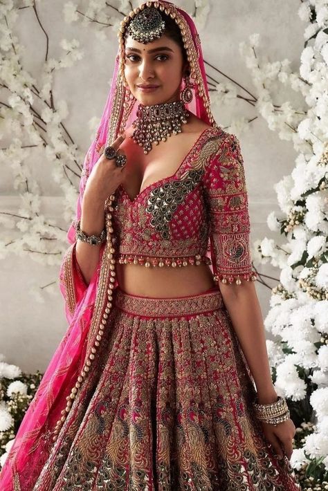 Planning to wear a pink bridal lehenga at your wedding? Here are 50+ bridal lehengas in all shades of pink to inspire you. Light Weight Bridal Lehenga, Indian Wedding Outfits Bridal Lehenga Red And Pink, Bridal Lehenga Designs Latest Pink, Bridal Lehenga Inspiration, Bridal Lehenga Latest Designs, Reception Blouse Design For Bride Pink, Bridal Lehenga For Wedding, Wedding Lehengas Bridal Pink, Lehenga For Wedding Brides