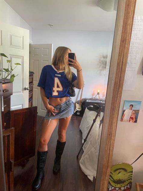 Bills jersey denim skirt leather boots Football Jersey Festival Outfit, Denim Shorts Party Outfit, Jersey And Denim Skirt Outfit, Jersey And Cowboy Boots Outfit, Football Jersey And Skirt Outfit, Cool Gameday Outfits, Jean Skirt Going Out Outfit, Mini Skort Ootd, Jersey And Shorts Outfit Women