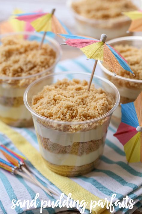 Sand Pudding Parfaits - a delicious Golden Oreo dessert with layers of pudding cream between. Luau Themed Decorations, Beach Theme Charcuterie Board Ideas, Surf Party Dessert Table, The Big One Food Ideas, Tropical Party Food Ideas, Sand Pudding Cups, Under The Sea Dessert Table, Pirate Lunch, Sand Dessert