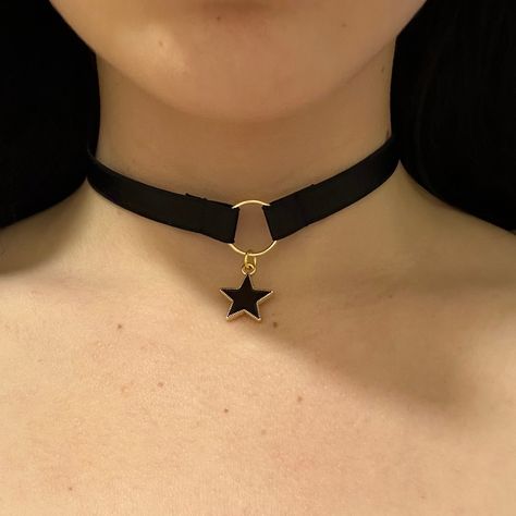 Choker is adjustable, and has a hook at the back. Introducing our celestial-inspired choker adorned with a delicate star charm, evoking the enchanting allure of the night sky. Crafted with precision and elegance, this choker gracefully encircles the neck, adding a touch of celestial glamour to any ensemble. With its subtle yet captivating design, it serves as a symbol of cosmic beauty and personal style. Elevate your look with this charming accessory that captures the magic of the stars. Adjustable Celestial Star Jewelry, Adjustable Celestial Jewelry For Parties, Trendy Adjustable Black Choker, Trendy Black Adjustable Choker, Trendy Star Charm Festival Jewelry, Black Adjustable Necklace With Star Charm, Adjustable Black Necklace With Star Charm, Adjustable Gold Edgy Choker, Edgy Gold Adjustable Choker