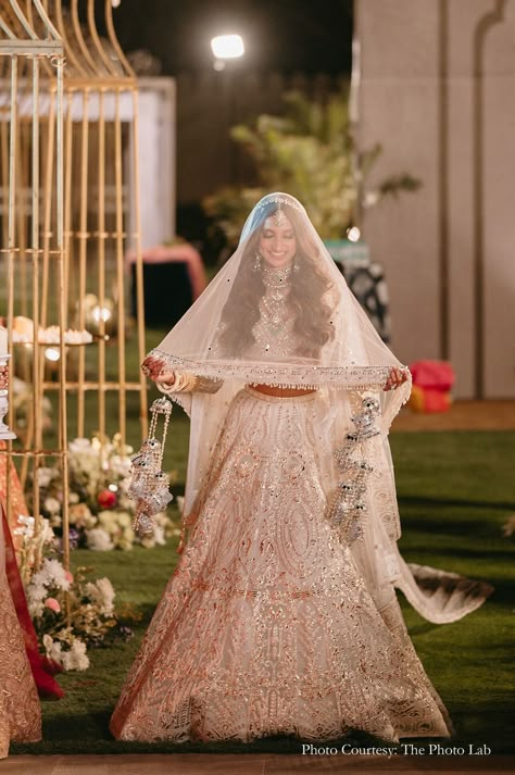 bride, ivory wedding lehenga, veil, bridal beauty, wedding glamour, ethereal elegance, wedding fashion, bridal inspiration, Indian wedding trends, stunning bride, wedding day, regal bride, ivory elegance, wedding attire, enchanting bride, bridal look bridal veil longs veils grace indian wedding indian bride wedding bride wedding sutra traditional fashion, bridal veil fashion, bridal fashion, veils, traditional veils white lehenga traditional look bridal white lehenga Lehenga Veil Indian Bridal, Indian Bride Veil, Bridal Veil Indian, Indian Wedding Veil, Poolside Wedding Ceremony, Veil Indian, Balloon Entry, Regal Bride, Lehenga Traditional