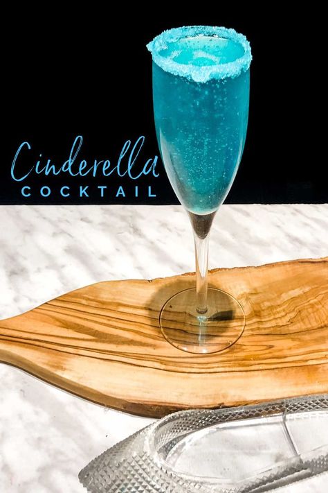 This Glass slipper Disney inspired Cinderella cocktail is perfect for any party or Royal ball! Adults will love this sparkly Dirty Cinderella cocktail and it is so easy to make with only 4 ingredients. If you love Champagne cocktails then you will love the Cinderella! Drink With Champagne, Cinderella Cocktail, Blue Cocktail Recipes, Tequila Sunrise Recipe, Princess Drinks, Blue Lagoon Cocktail, Disney Inspired Cocktails, Rainbow Cocktail, Disney Cocktails