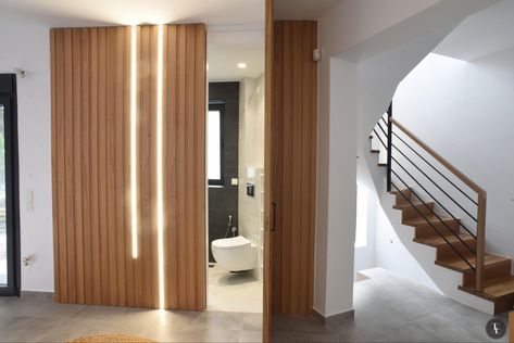 Wood panel stripped wall with hidden door with bathroom inside and led gramic stripped neon lights. Wall With Hidden Door, Stripped Wall, Homemade Lasagna, Door Bathroom, Hidden Door, Wood Panel, Wall Panel, Neon Lights, Neon Lighting