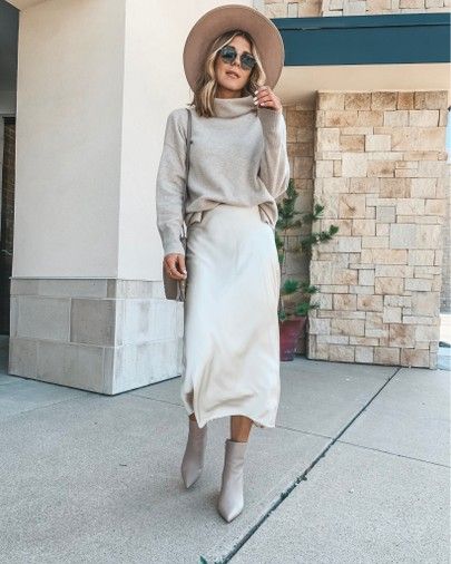 Cream Wool Skirt Outfit, Cream Satin Skirt Boots, Satin Dress Sweater Outfit, Cream Felt Hat Outfit, Cream Satin Skirt Outfit Fall, Satin Skirt With Boots, Elegant Beige Winter Fedora, Cream Booties Outfit, Slip Skirt Outfit Winter