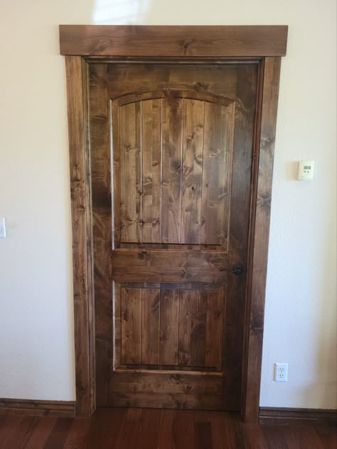 Cabin Interior Doors And Trim, Stained Bedroom Doors, Rustic Wood Trim Ideas, Knotty Alder Trim And Doors, Stained Interior Door, Black Interior Doors With Wood Trim, Natural Wood Baseboards, Farmhouse Doors Interior, Rustic Door Trim