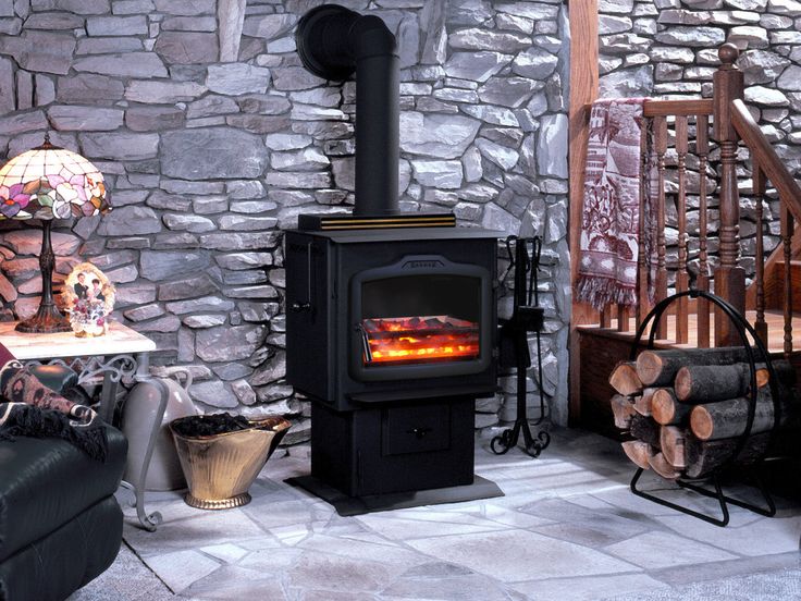 a wood burning stove sitting inside of a living room next to a chair and fire place