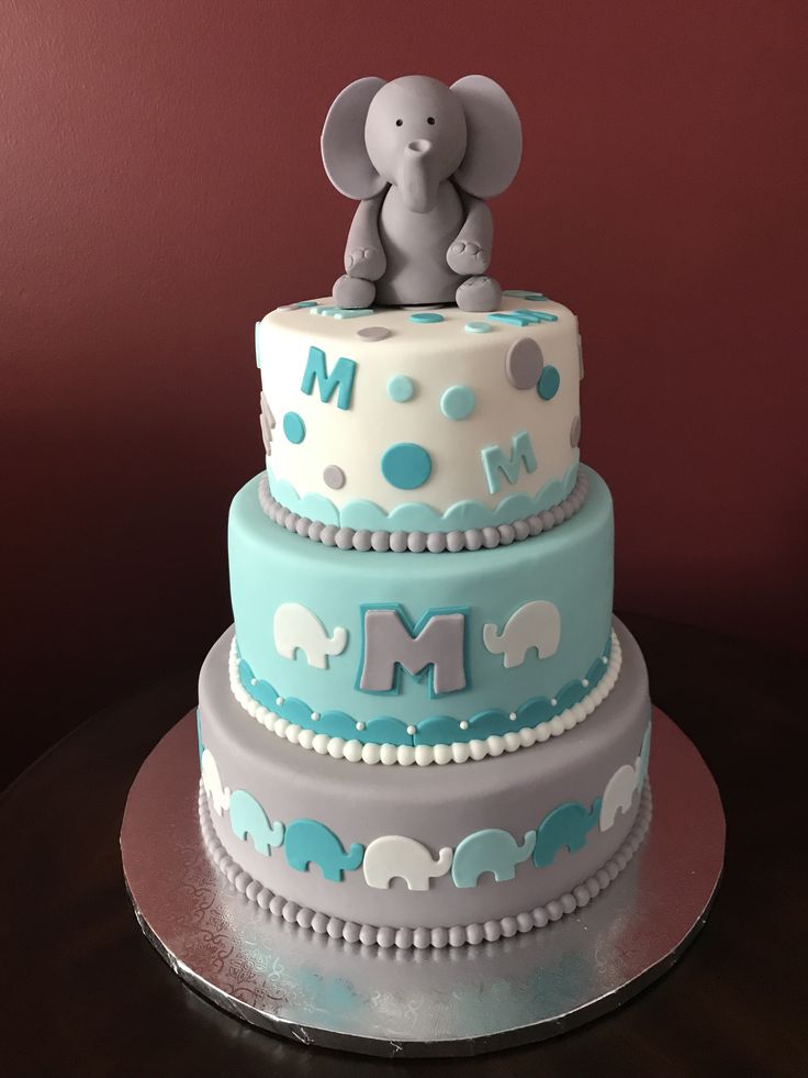 a three tiered cake with an elephant on top