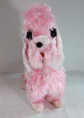 a pink stuffed dog with black eyes and long fur on it's back legs