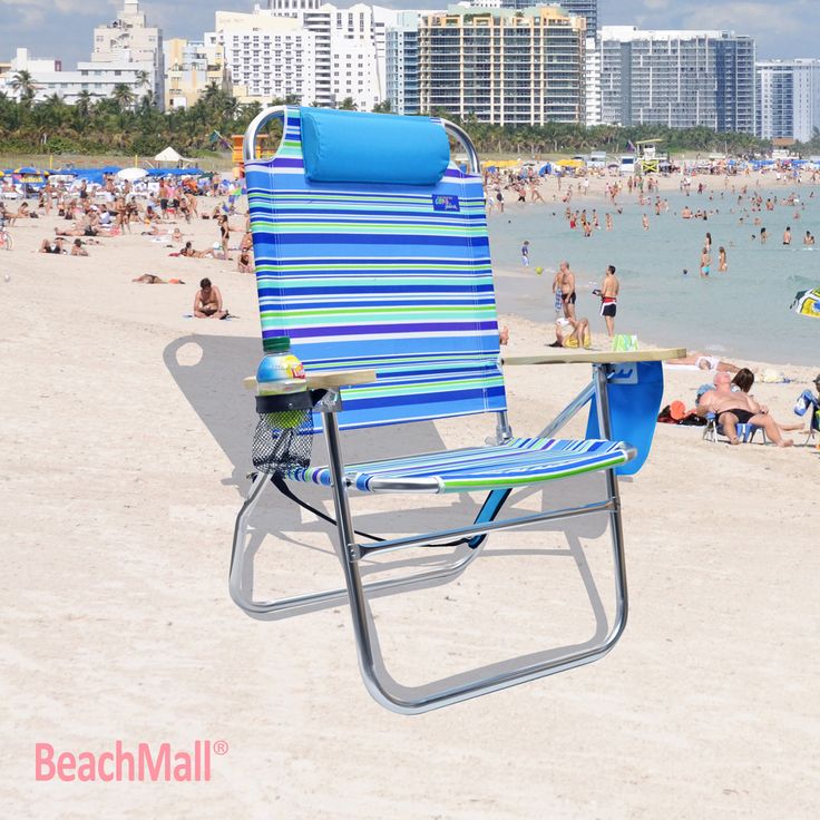 a blue and white beach chair sitting on top of a sandy beach