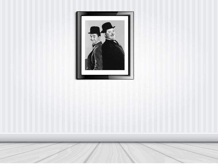 an empty room with two framed photos hanging on the wall