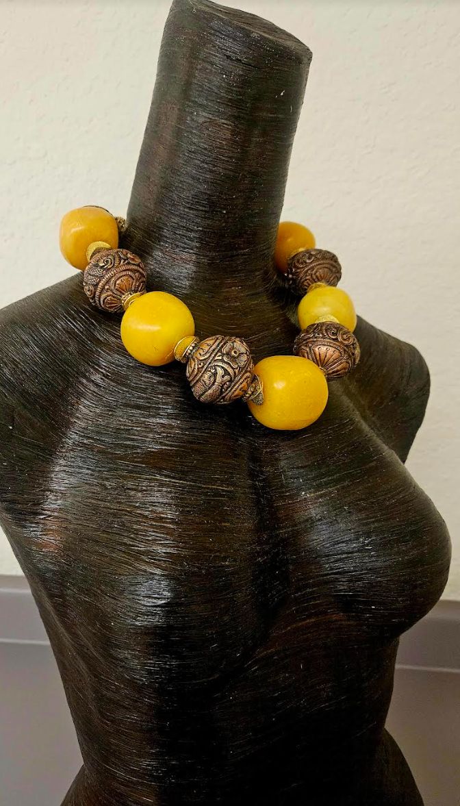 This stunning homage to Iris Apfel is from my private collection and is new and unworn. Five big, bold and chunky predominantly yellow (with a tinge of orange) Copal Amber beads are alternated with huge and ornate Tibetan Copper Repousse Beads. Each copal bead ranges in size from the smallest at 1.5" to the largest at 1.75". I did the water floatation test on these beads and they did indeed float! Separating all the large beads is a pair of burnished gold tone metal wavy potato chip spacers. Thi Luxury Handmade Baltic Amber Necklace, Luxury Brown Baltic Amber Necklace, Handmade Yellow Baltic Amber Necklace, Traditional Amber Beads, Gems And Cabochons, Turquoise Western, Jewellery Shop Design, Orange Amulet-style Jewelry With Large Beads, Large Beads, Potato Chip