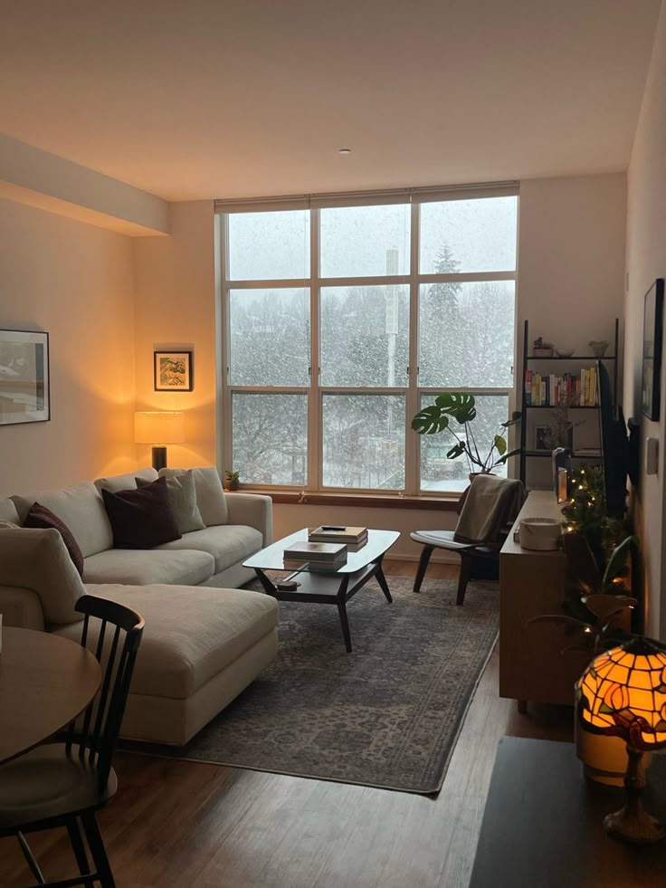 a living room filled with furniture and a large window