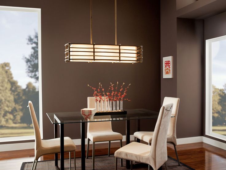 a dining room table with four chairs and a glass top centerpiece hanging from the ceiling