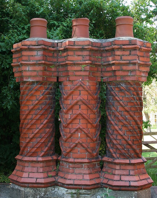 three brick chimneys are stacked on top of each other