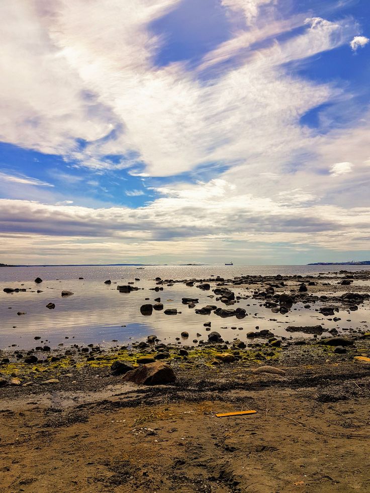 there are rocks in the water and blue sky