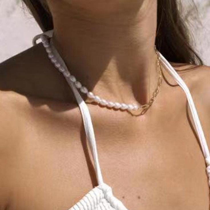 Add a touch of elegance and edge to your outfit with our Pearl & Chain Necklace. The lustrous pearls paired with a bold chain create a unique and sophisticated look. Perfect for any occasion.