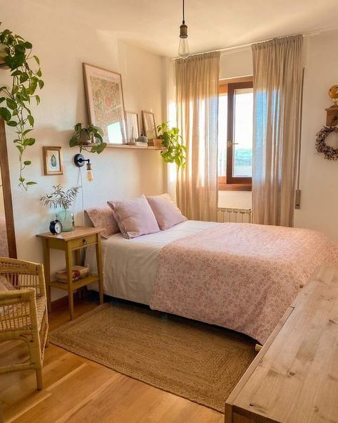 a bed sitting in a bedroom next to a wooden table and chair on top of a hard wood floor