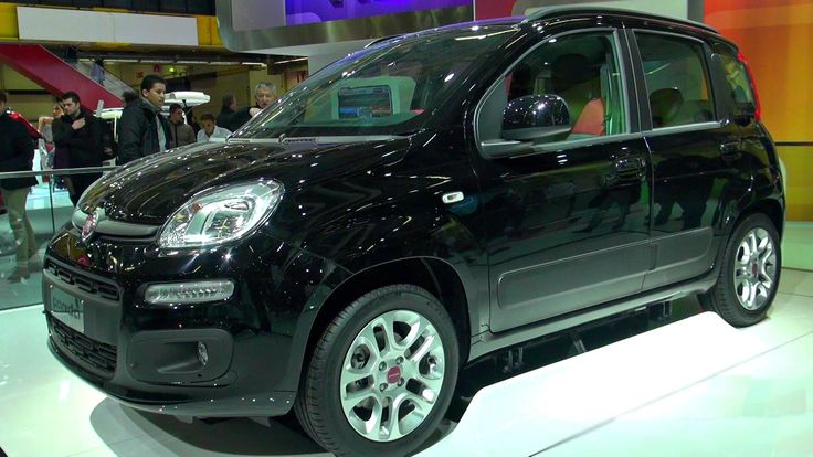 a small black car on display at an auto show