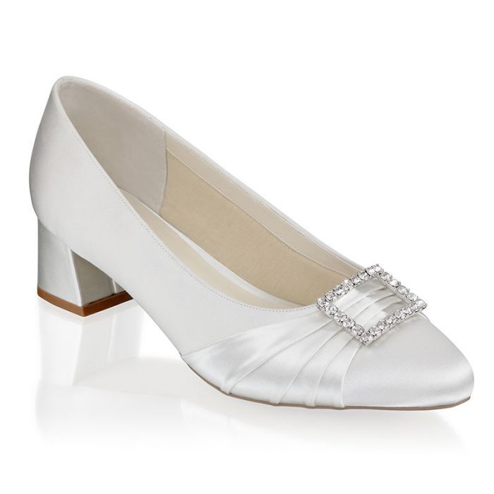 a woman's white wedding shoe on a white background