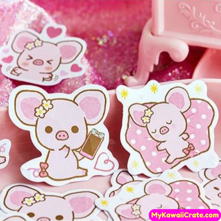 some pink stickers with little pigs on them sitting next to a chair and table