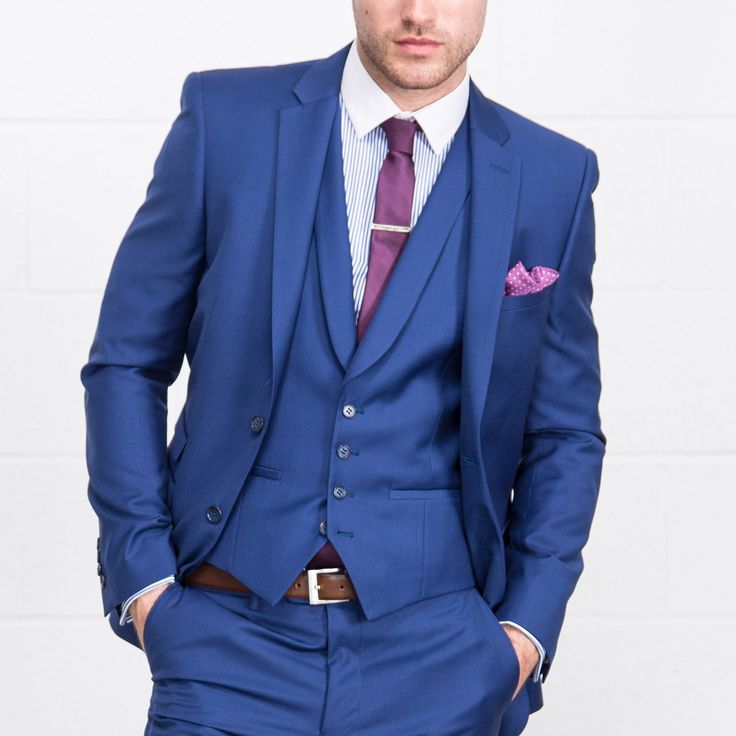 a man in a blue suit and purple tie