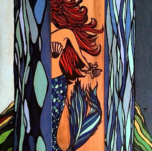 a painting of a mermaid with long red hair