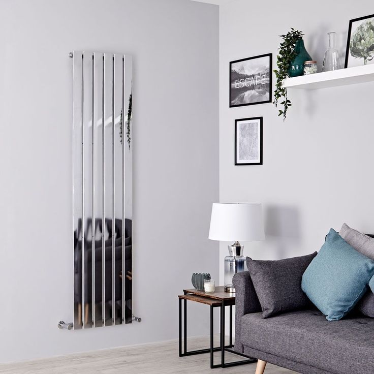 a living room with a couch, table and radiator next to it on the wall