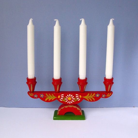 a red and white candelabra with four candles