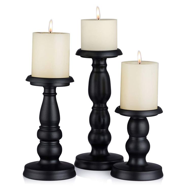 three black candles sitting next to each other