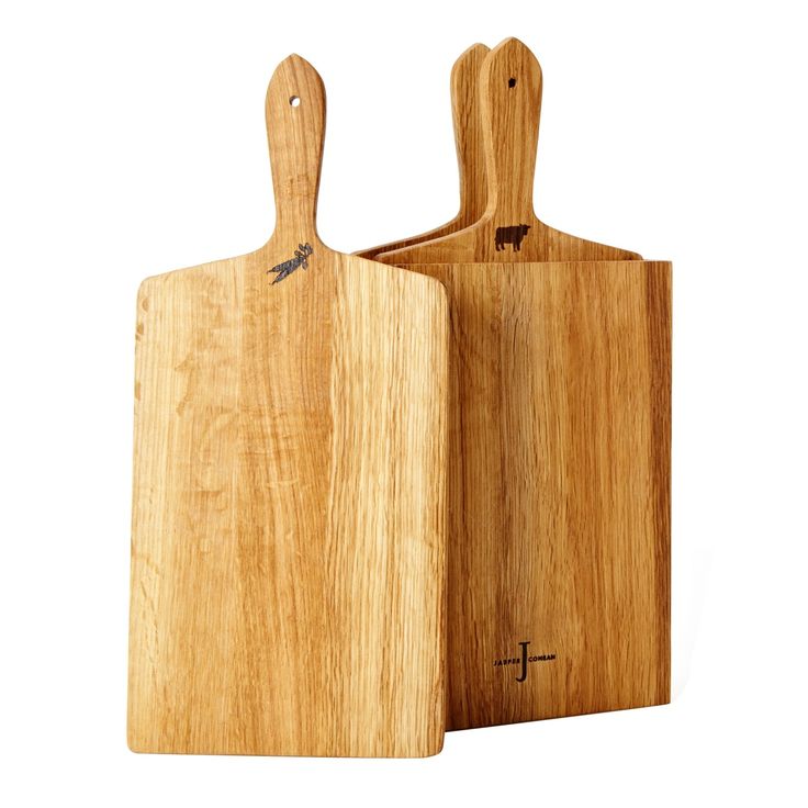 two wooden cutting boards sitting next to each other