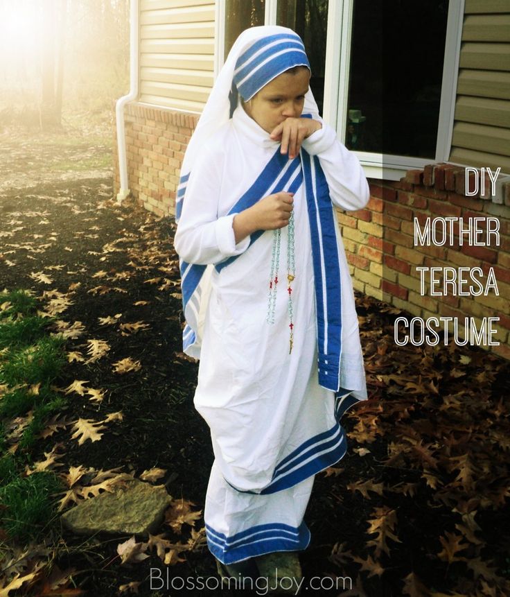 a woman dressed in white and blue is standing outside her house with leaves on the ground