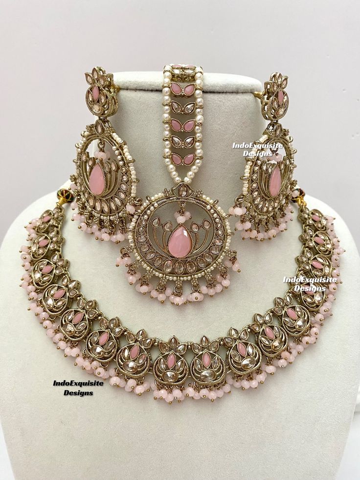 Gorgeous Antique gold Polki Necklace Set comes with elegant earrings and tikka / Indian Jewelry/ High Quality Kundan and Polki Jewelry/ Bollywood Jewelry/Wedding Jewelry/pink All items are shipped from Brampton, Ontario, Canada. If you need your item by a certain day, please reach out to us for express delivery option before placing the order so that we can update the shipping for you. Standard shipping/delivery timeline Below are the estimated delivery times after the order is shipped/dispatche Pink Bridal Sets For Party And Festive Occasions, Pink Bridal Sets For Party, Festive Pink Bridal Sets For Party, Pink Elegant Kundan Tikka, Elegant Pink Kundan Tikka, Pink Jewelry Sets For Diwali Party, Pink Chandbali Tikka As Gift, Pink Stone Work Tikka As Gift, Bollywood Style Pink Tikka With Stone Work