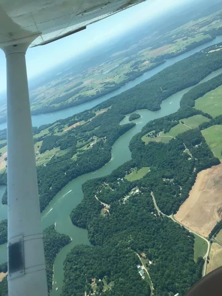 the view from an airplane looking down on a river and land