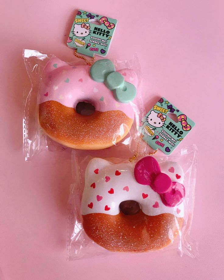 two hello kitty donuts with pink frosting and sprinkles on them