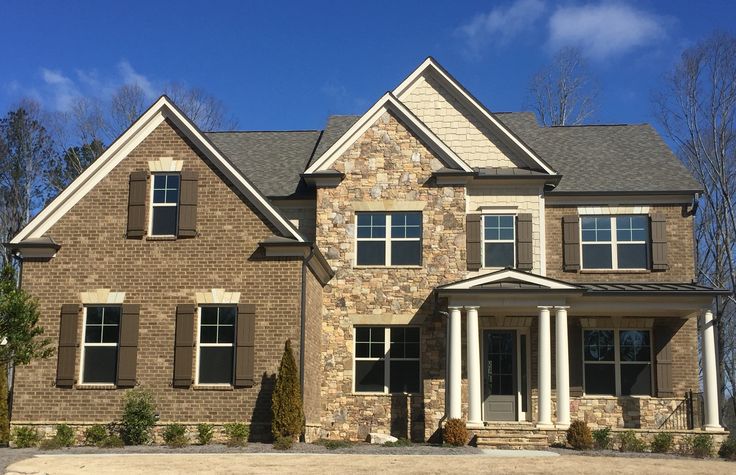 a large brick house with white columns and windows