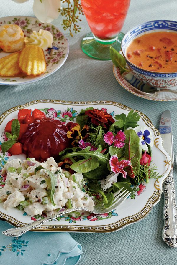 there is a plate with salad and soup on it